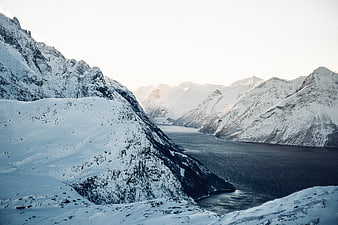Snow-Covered Mountain Fjord Landscape in Winter