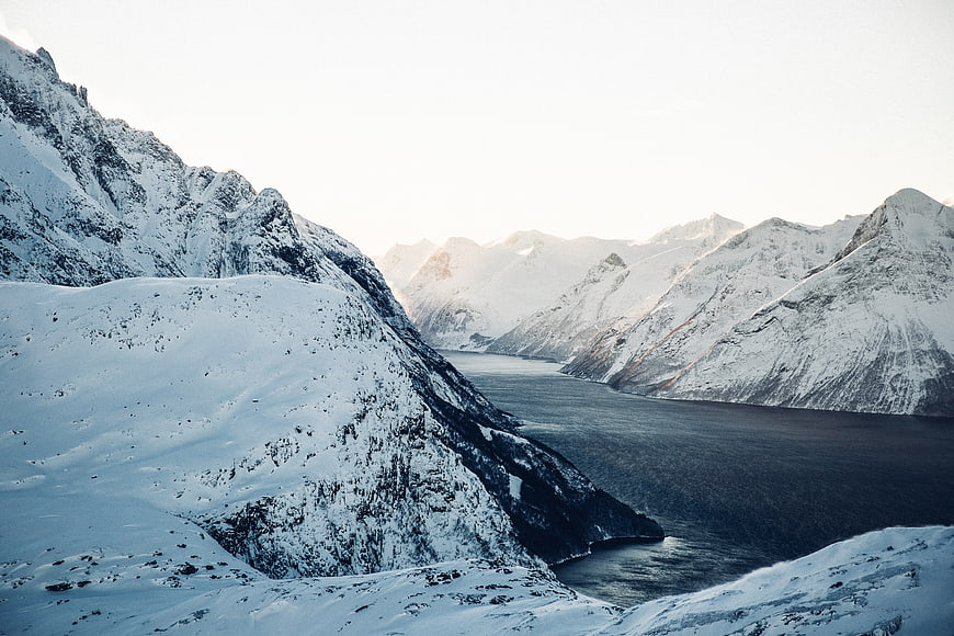 Snow-Covered Mountain Fjord Landscape in Winter