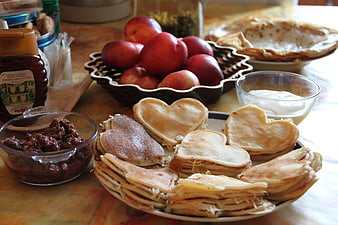Heart-Shaped Pancakes With Apples And Jam On A Wooden Table