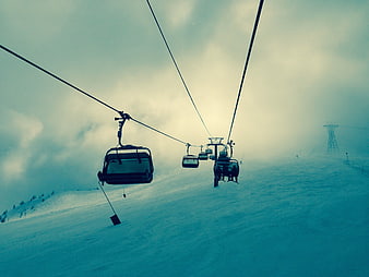 Ski Lift Chairs on Snowy Mountain Slope in Fog