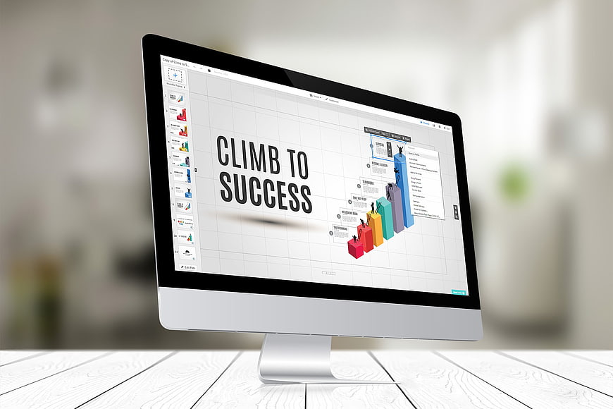 Computer monitor displaying climb to success presentation