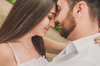 Romantic Close-Up of Young Couple Foreheads Touching Outdoors