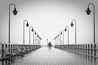 Couple Walking Under Umbrella on Rainy Pier