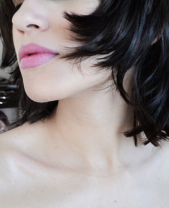 Close-up of woman's lips and chin with black hair