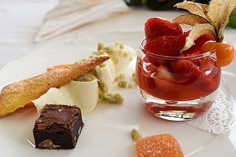 Assorted dessert plate with chocolate brownie, strawberry jelly, and pastry