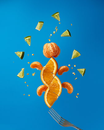 Floating citrus fruits and lime slices on blue background