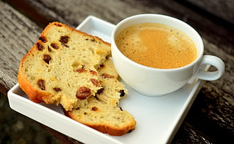 Coffee and Raisin Bread on Wooden Table