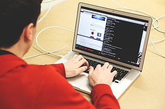Programmer typing code on MacBook Pro laptop
