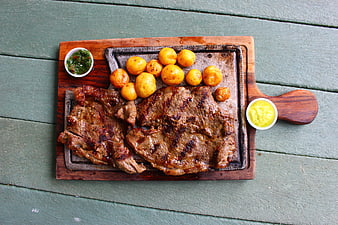 Grilled Steak and Roasted Potatoes on Wooden Board