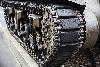 Close-up of heavy military tank tracks and drive sprocket