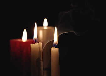 Lit Candles with Smoke on Black Background