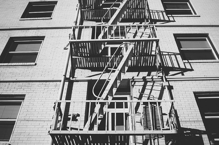 Black and white fire escape on brick building facade