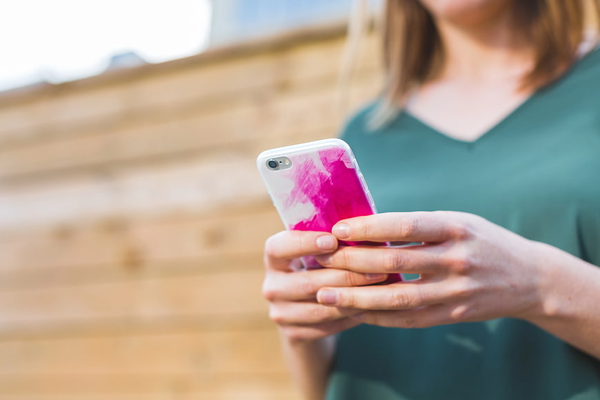Close-up of Woman Using Smartphone with Pink Case