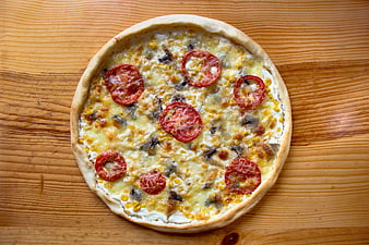 Homemade Pizza with Tomatoes and Corn on Wooden Table