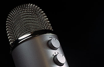 Close-up of silver condenser microphone on black background