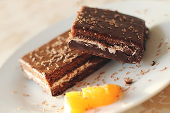 Chocolate Brownie Dessert with Orange Slice on White Plate