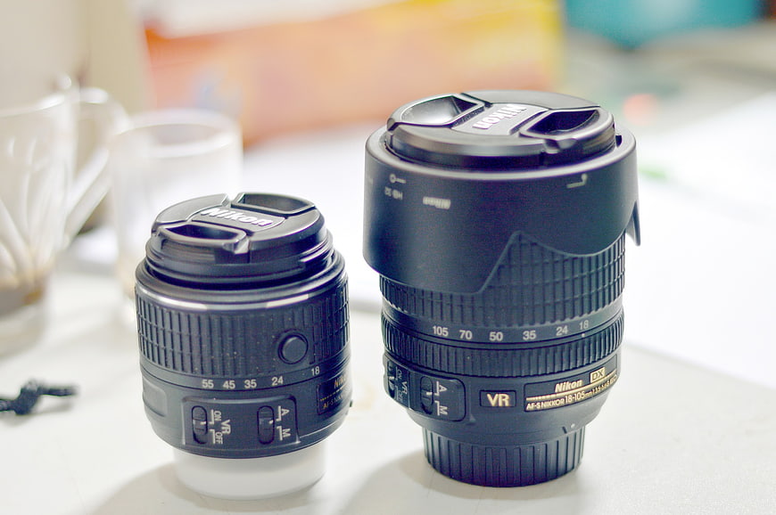 Two Nikon Camera Lenses on White Table