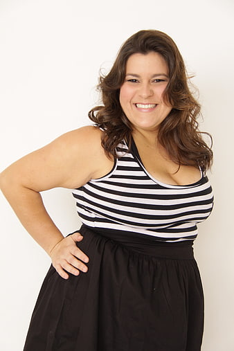 Smiling plus size woman in striped top and black skirt