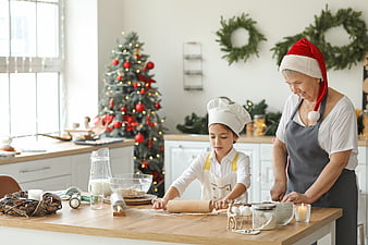 Grandmother and granddaughter baking Christmas cookies in kitchen