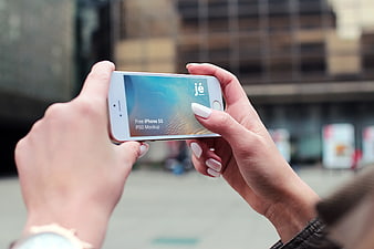 Hands holding white iPhone 5s with mockup screen