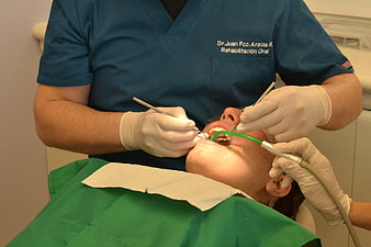 Dentist performing oral rehabilitation procedure on patient