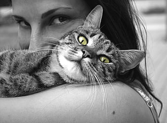 Black and white photo of woman holding tabby cat