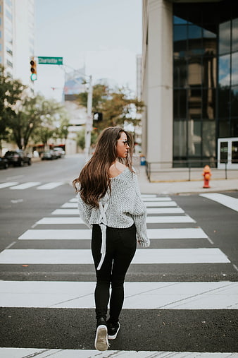 Woman in Knit Sweater Walking Across City Crosswalk