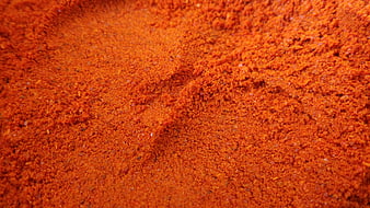 Close-up texture of vibrant red chili powder seasoning