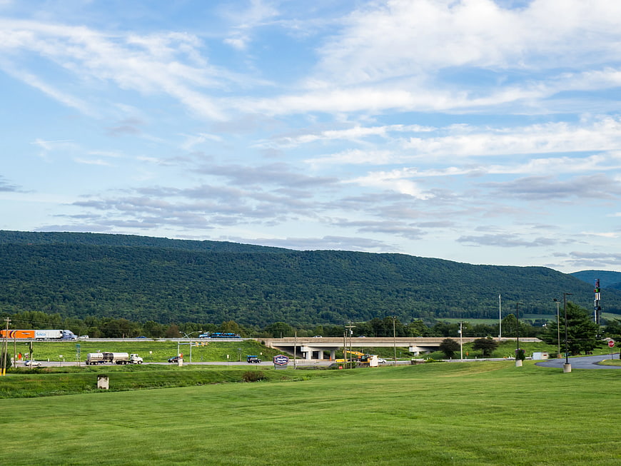 Highway Overpass and Green Mountain Landscape