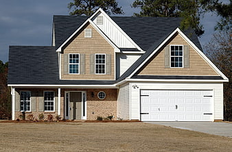 Modern suburban home with beige siding and white garage