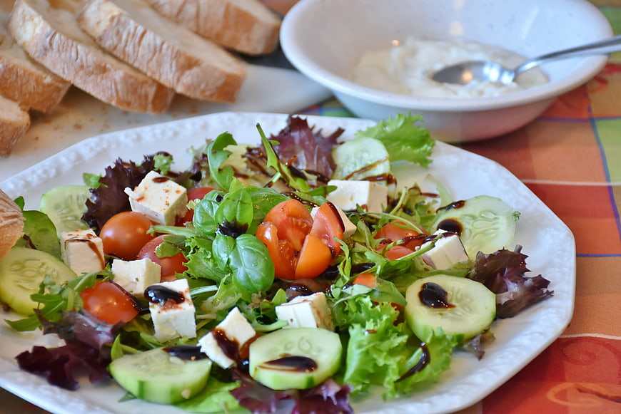 Fresh Mediterranean salad with feta, cucumber, and tomatoes on a white plate