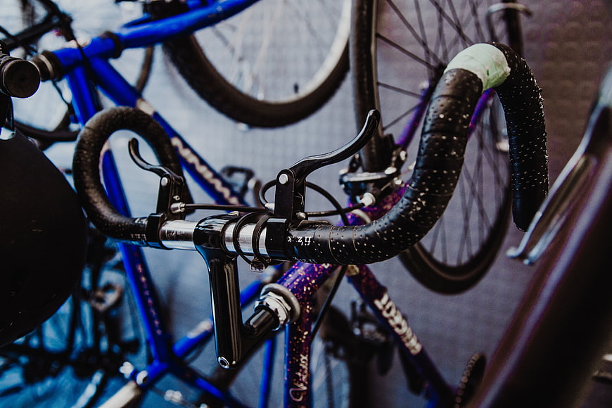 Close-up of wet bicycle handlebars in a bike shop