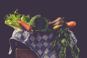 Fresh organic vegetables on checkered cloth rustic still life