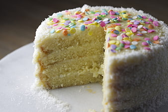 Close-up of layered coconut cake with colorful sprinkles