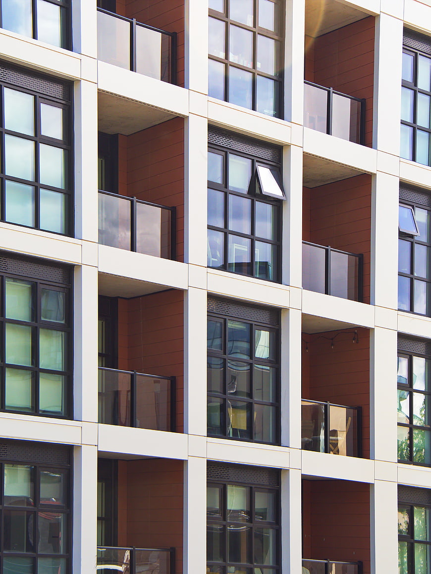 Modern Apartment Building Facade with Balconies and Windows