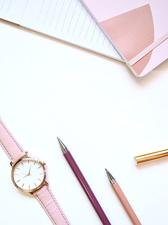 Pink Watch, Pens, and Notebook Flat Lay on White Background