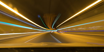 Abstract light trails speeding through a tunnel at night