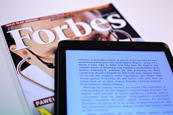 Forbes Magazine and E-reader Tablet on White Background
