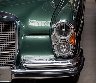 Close-up of Classic Green Mercedes-Benz Headlights and Chrome Bumper