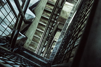 Abstract industrial concrete stairwell with metal railings