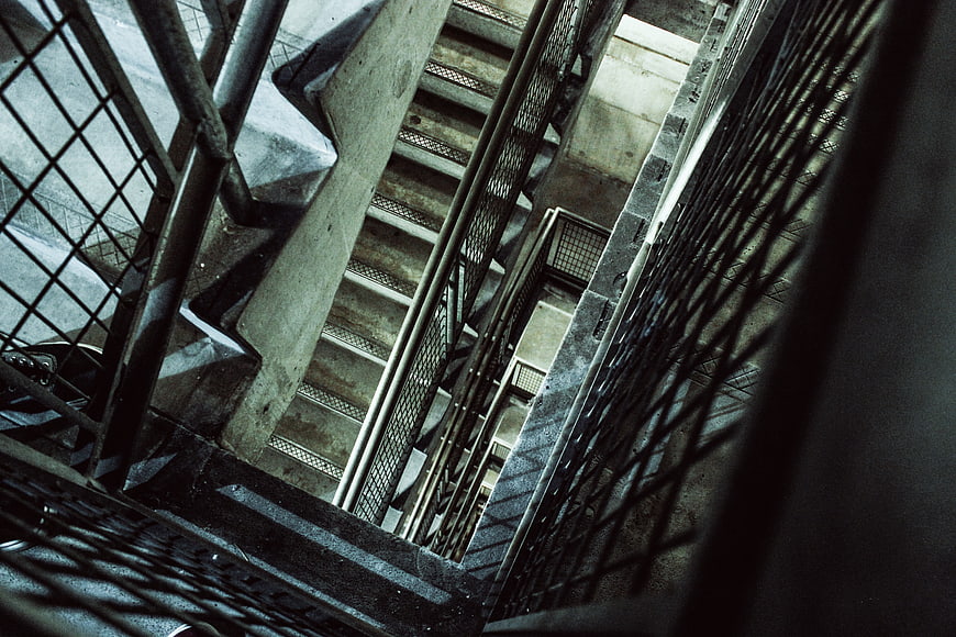 Abstract industrial concrete stairwell with metal railings