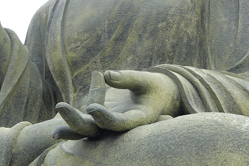 Close-up of Stone Buddha Hand in Meditation Mudra