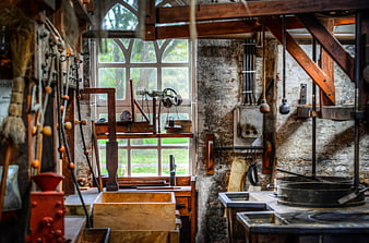 Rustic interior of an old mill with vintage machinery and stone walls
