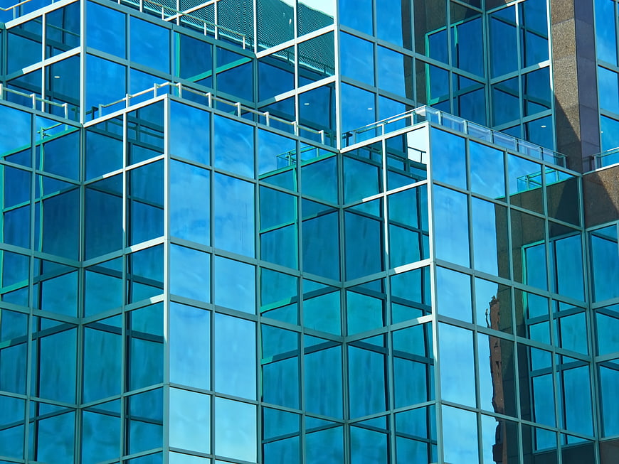Modern Blue Glass Skyscraper Facade with Sky Reflections
