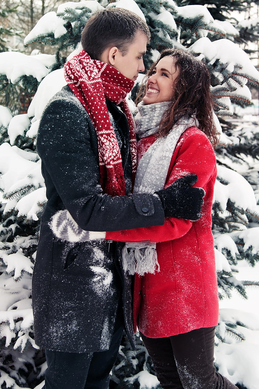 Happy Couple Embracing in Snowy Forest