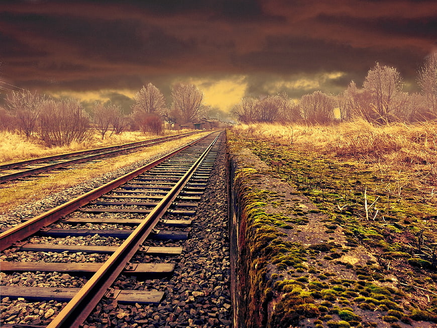 Dramatic Railway Tracks Leading Through Rural Landscape