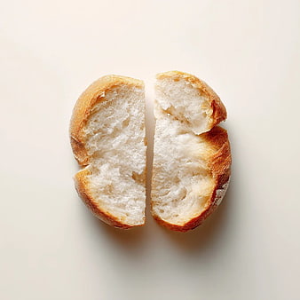 Freshly Baked Crusty Bread Halves on White Background