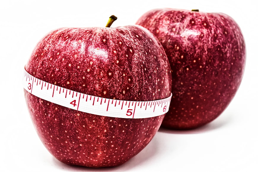 Red Apples With Measuring Tape On White Background