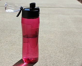 Pink Water Bottle on Concrete Surface