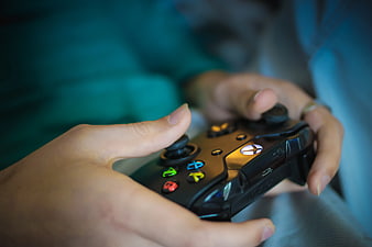 Close-up of Hands Holding Black Xbox Controller